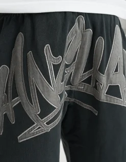 Vanguard Graffiti Baggy Track Pants in Washed Black